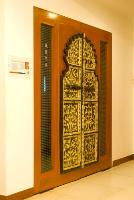 an old Rajasthani door panel fused within a modern wooden door frame.